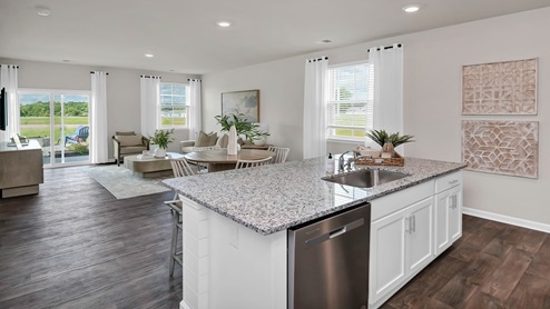 The floating kitchen island overlooks the open concept dining and living areas.