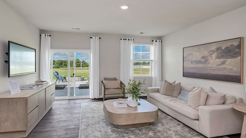 The living area is spacious with several large windows.