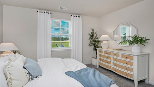 The primary bedroom is located towards the back of the home and comfortably fits a king bed.