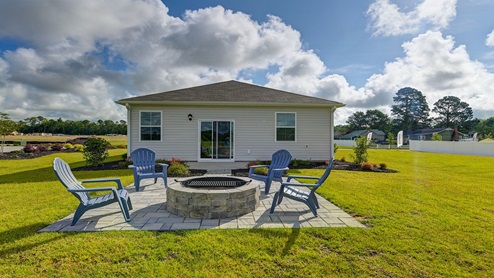 The paved back patio offers space for furniture or a firepit.