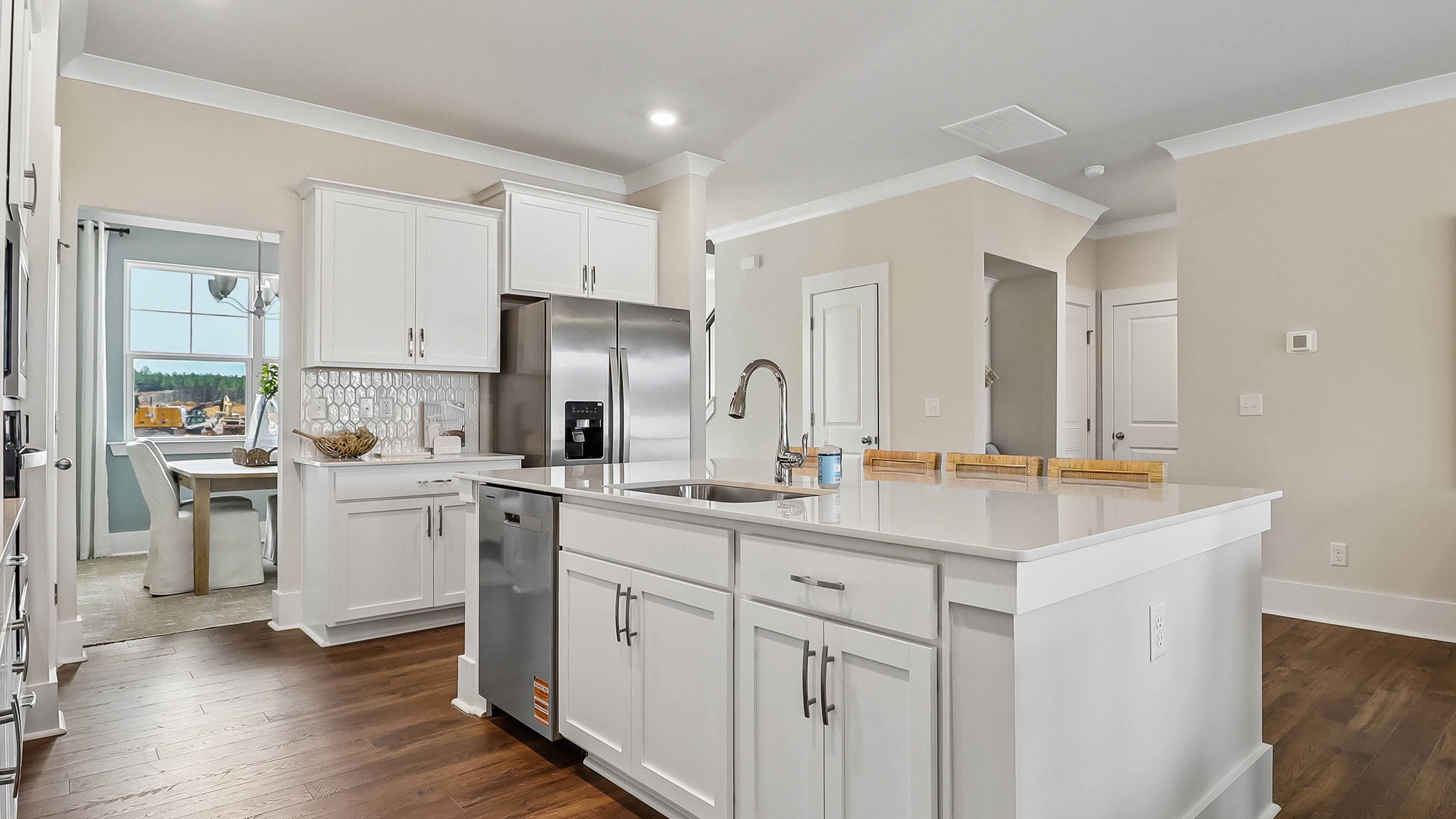 Floating kitchen island with shaker-style cabinets and space for barstool seating