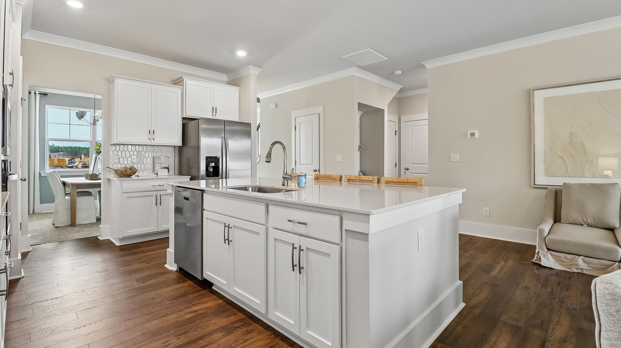 Floating kitchen island with shaker-style cabinets and space for barstool seating