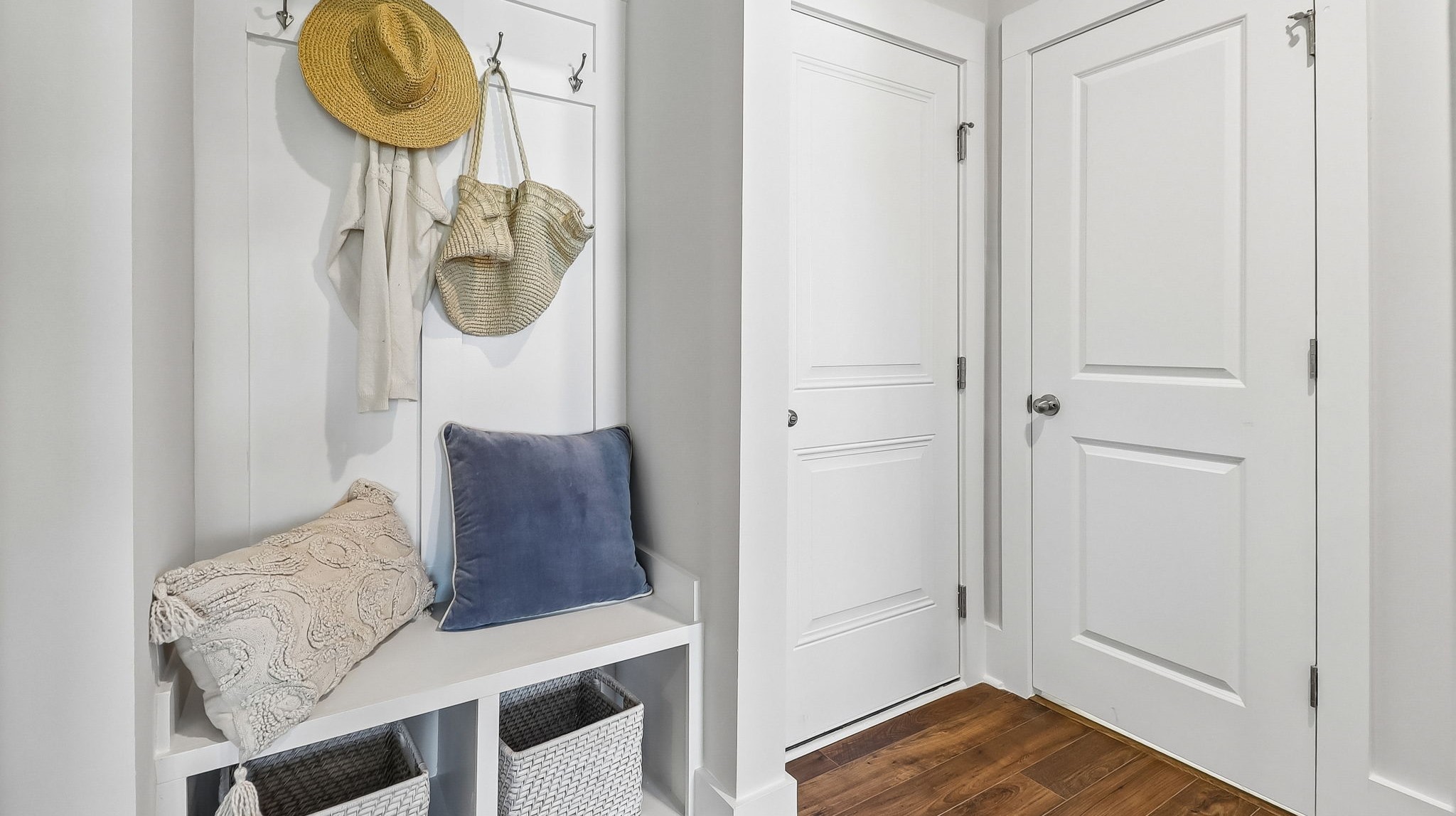 Small mudroom space near the garage door to hang coats and leave shoes