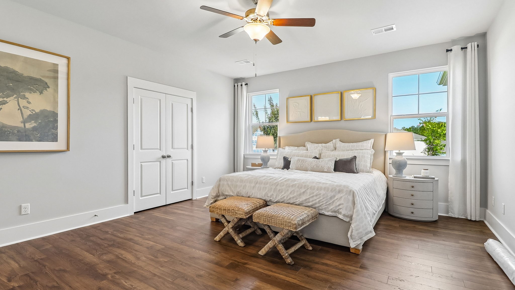 Private primary suite on the first floor with windows for light and RevWood flooring