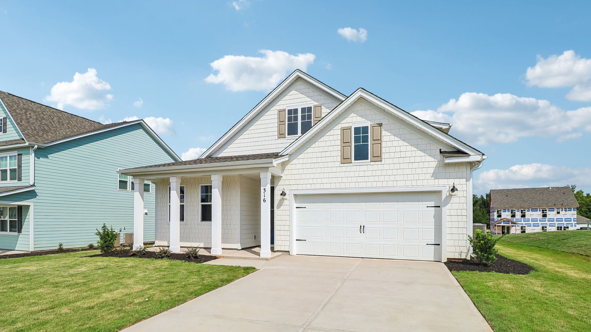 2-car garage and covered front porch on home for sale in Shell Pointe