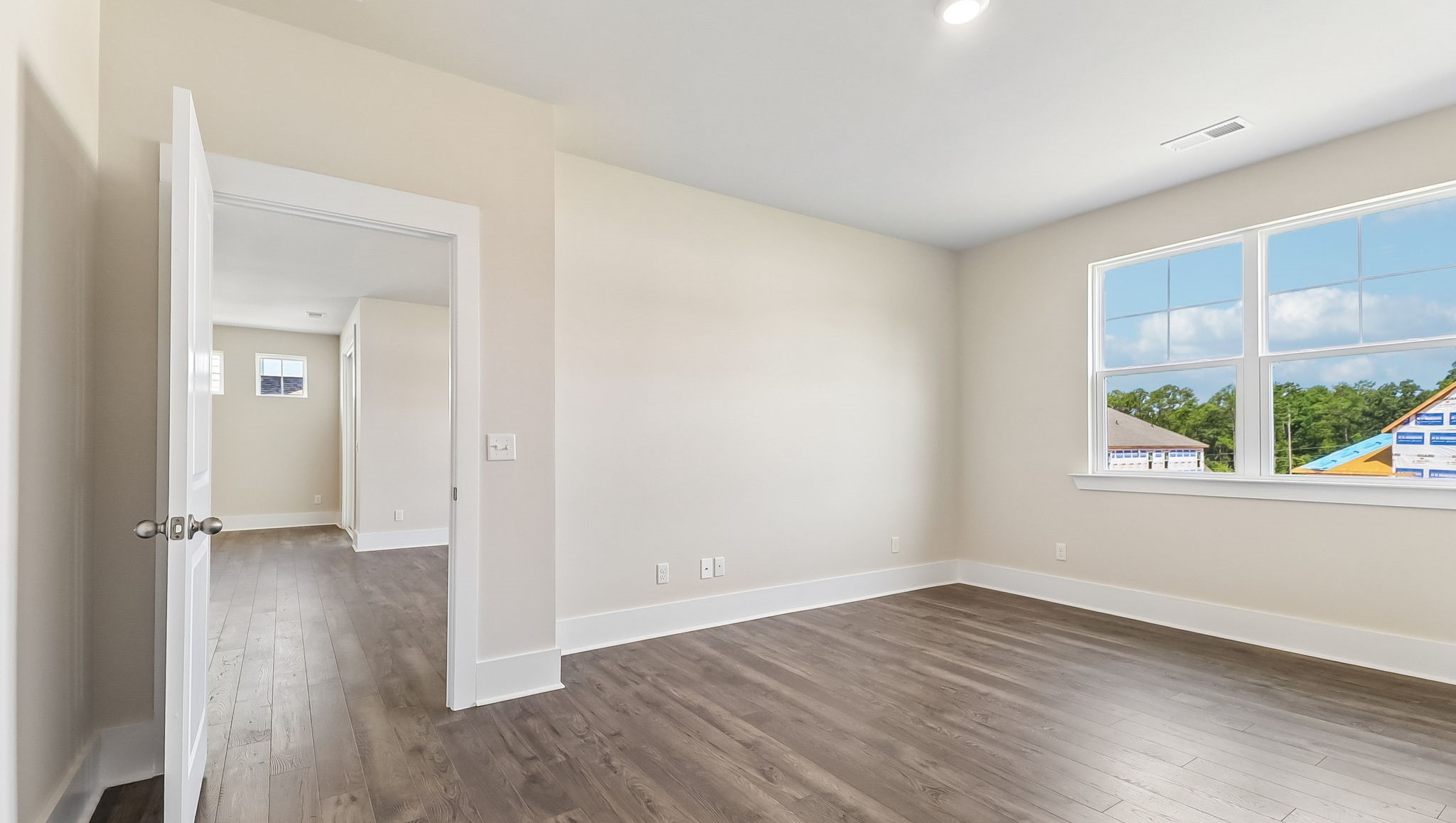 Primary suite is privately located at the back of the home