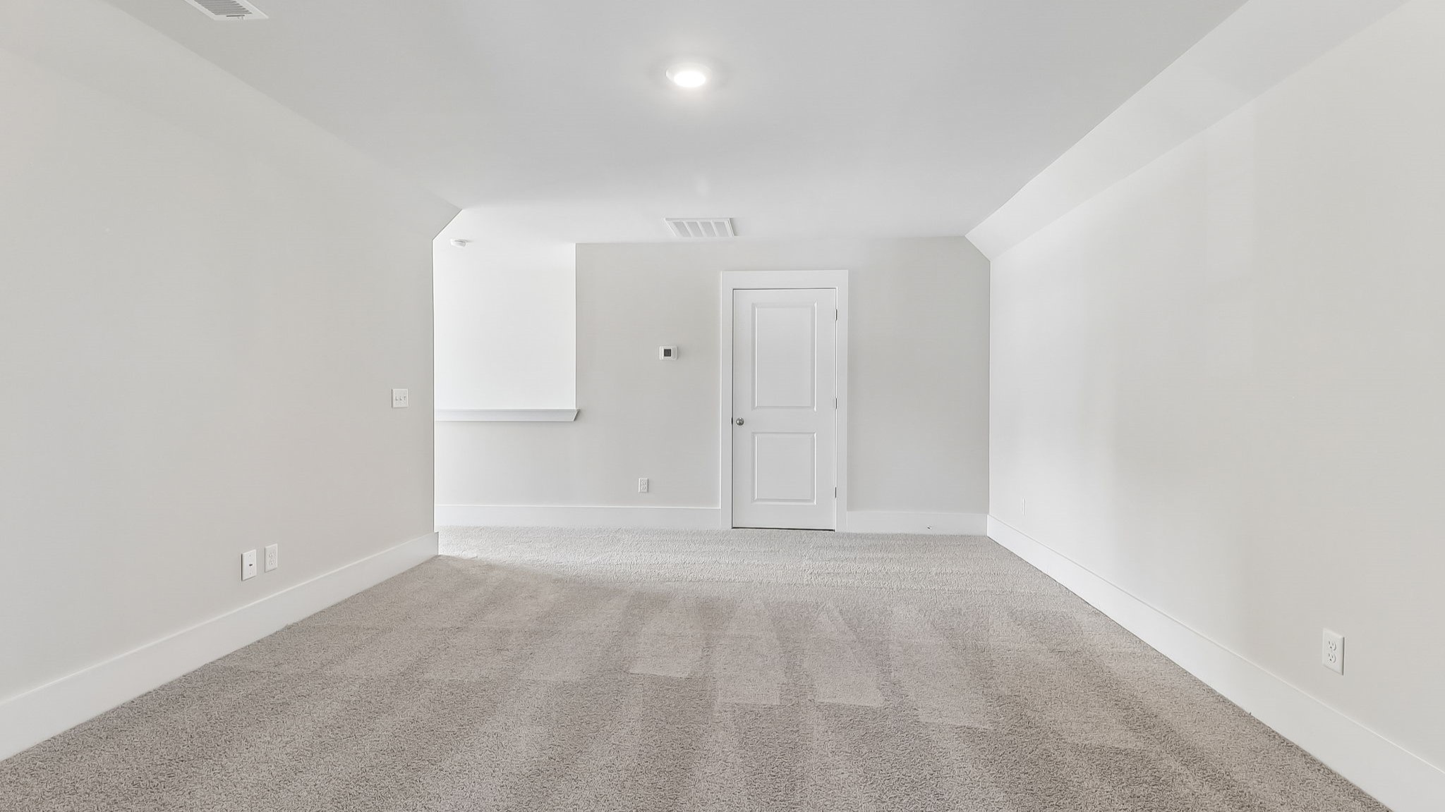 Finished bonus room upstairs with carpet flooring