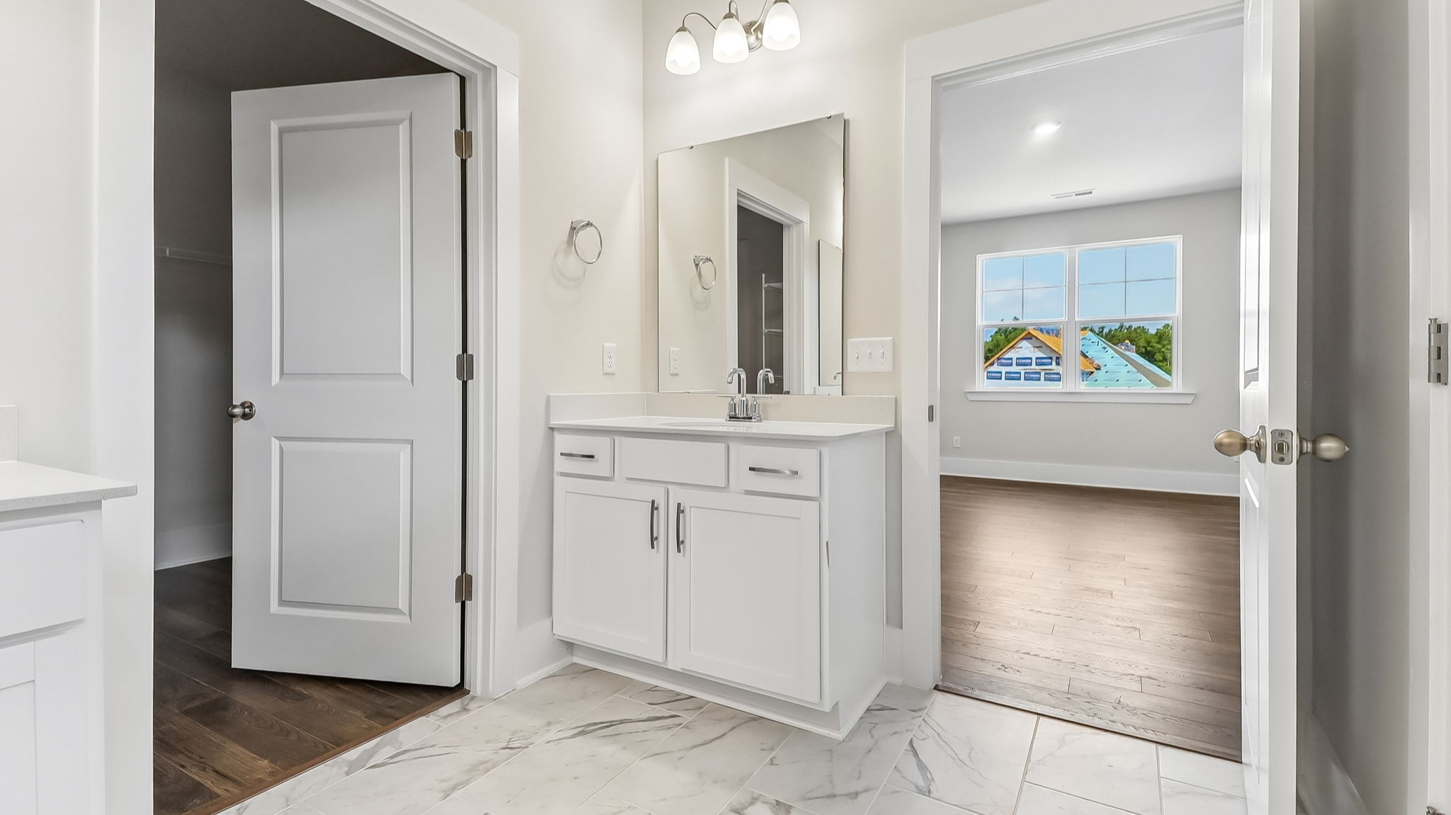 Second primary vanity and a walk-in primary closet