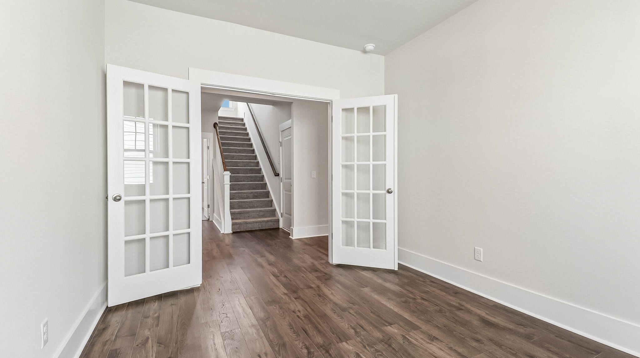 The flex space features French doors and could be used as a dedicated home office or formal dining area