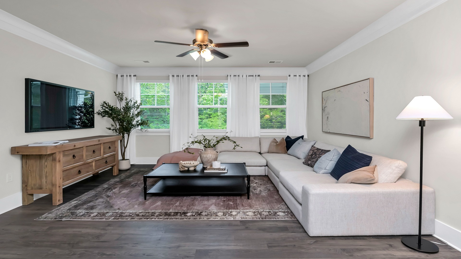 Living area with several windows and Revwood flooring