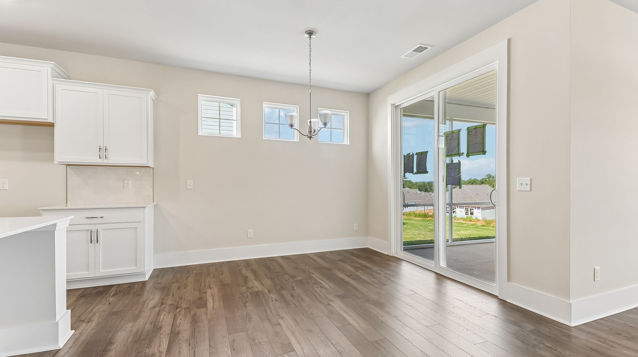 Open concept dining and kitchen areas with Revwood flooring