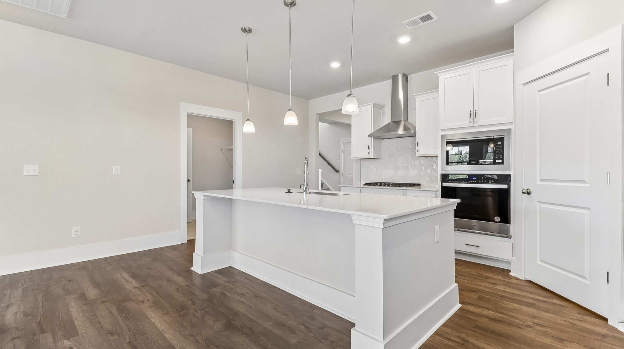 Tile backsplash also finishes the kitchen area, as well as a hood over the stovetop
