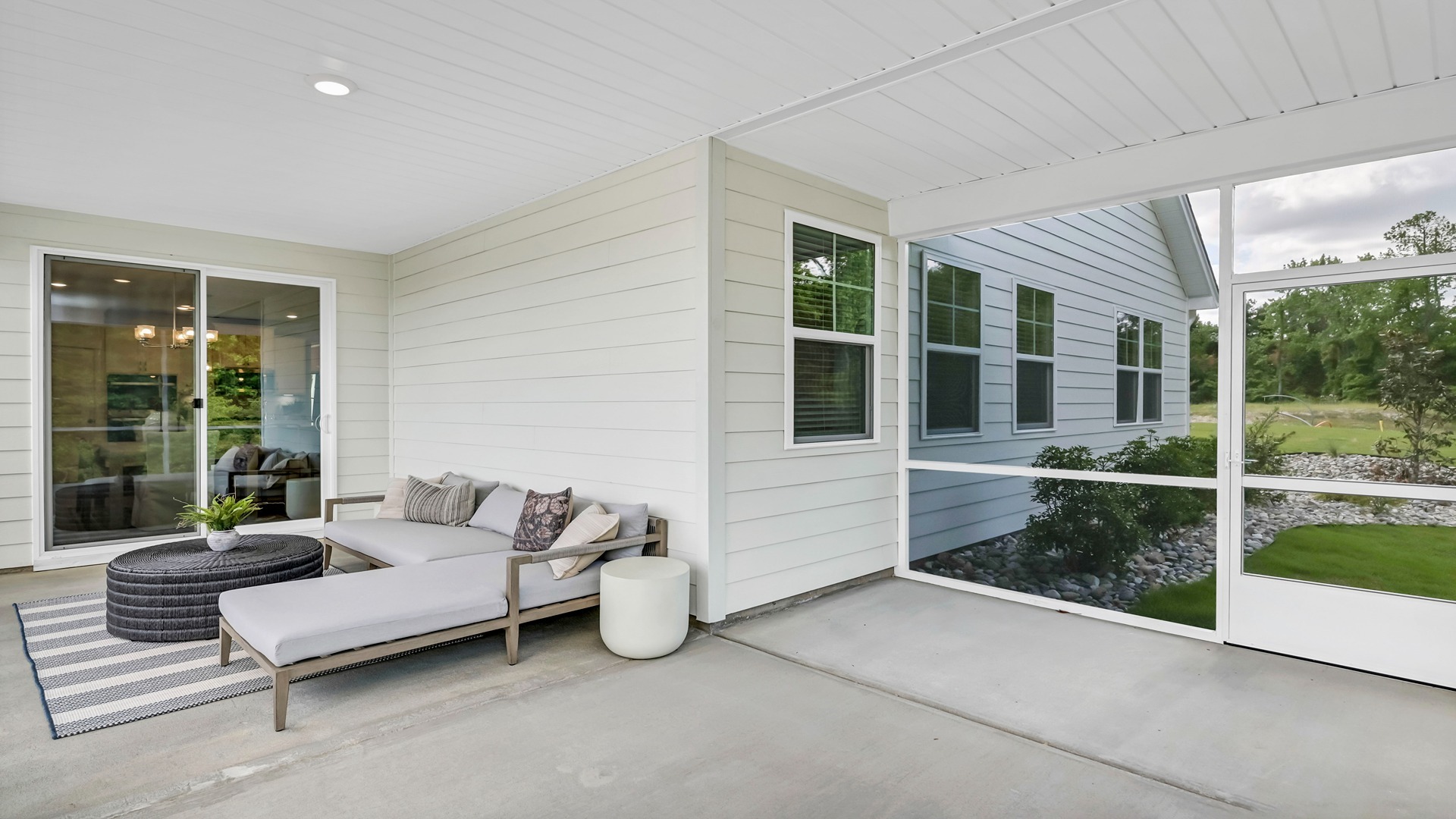 Extended, paved, covered, and screened-in back patio