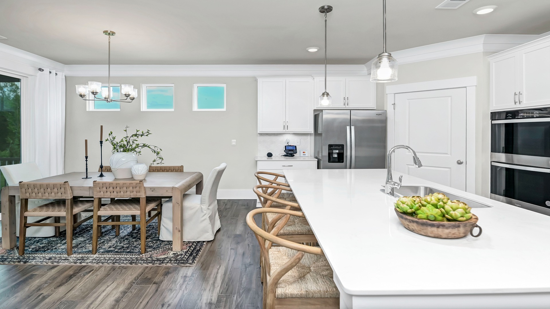 Open concept dining and kitchen areas with matching Revwood flooring