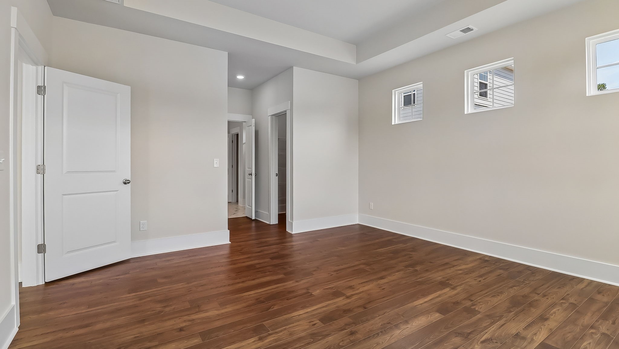 Natural light in primary bedroom from lots of windows
