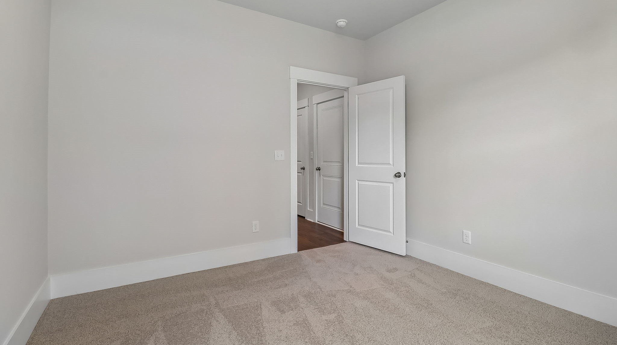 Bedroom 4 centrally located in the home near the laundry room