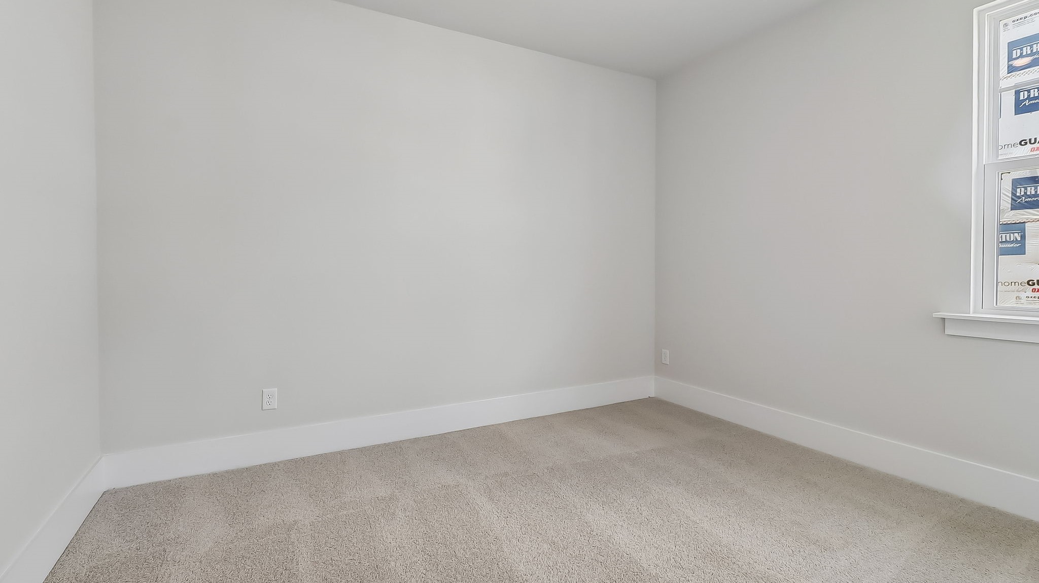 Bedroom 3 with carpet floors and a window