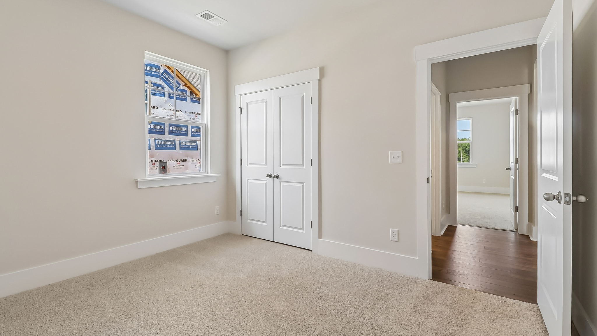 Bedroom 3 in the Litchfield floorplan with carpet floors and a window for light