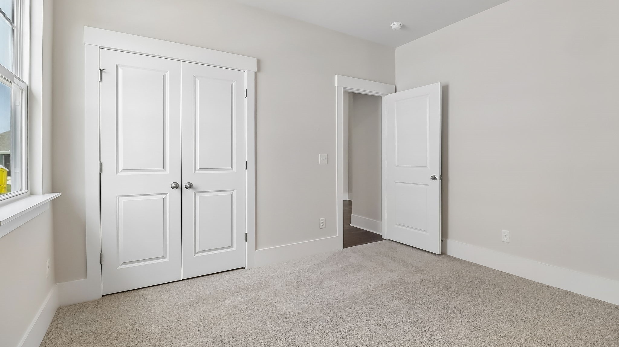 Bedroom 3 with French closet doors in new construction home for sale in Shell Pointe