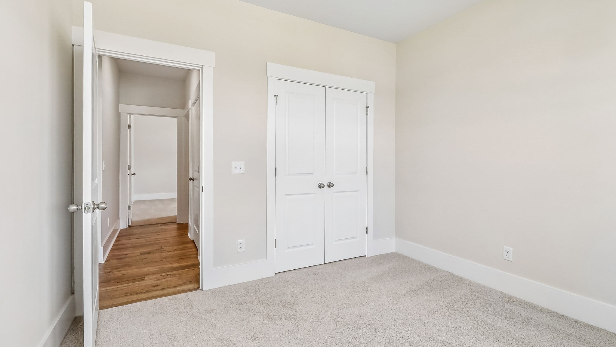 Bedroom 3 with French closet doors and carpet floors