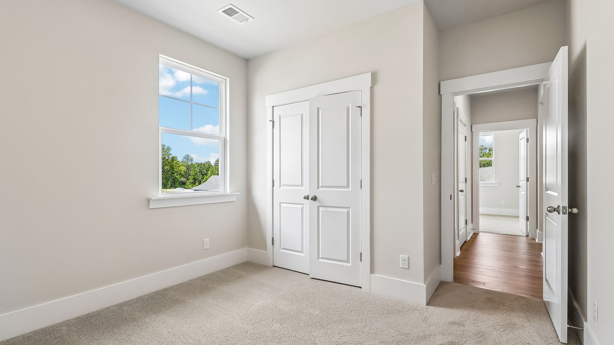 Bedroom 2 with a window for light and carpet floors
