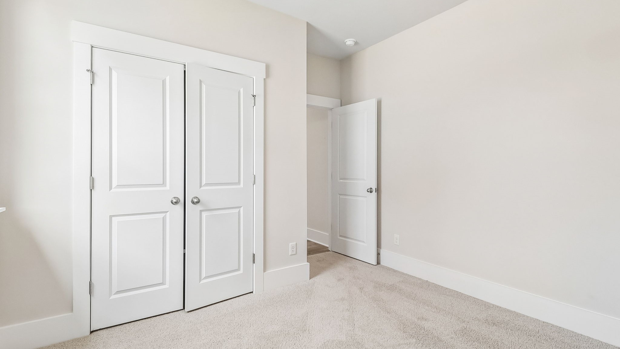 French closet doors in bedroom 2 of the Trivecta floorplan for sale in Gilbert, SC