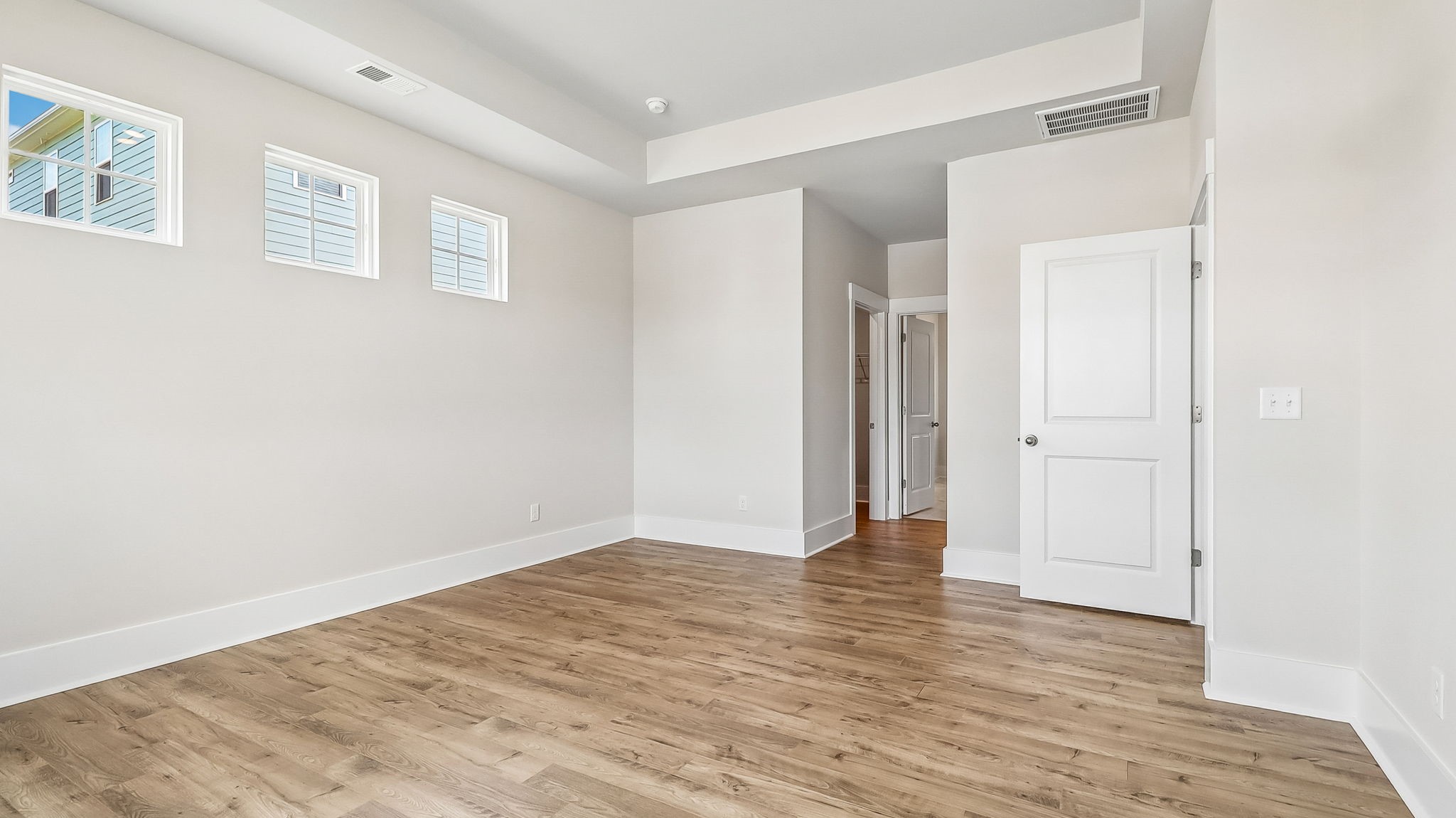 Spacious primary bedroom at the back of new construction single-story home for sale in Gilbert, SC