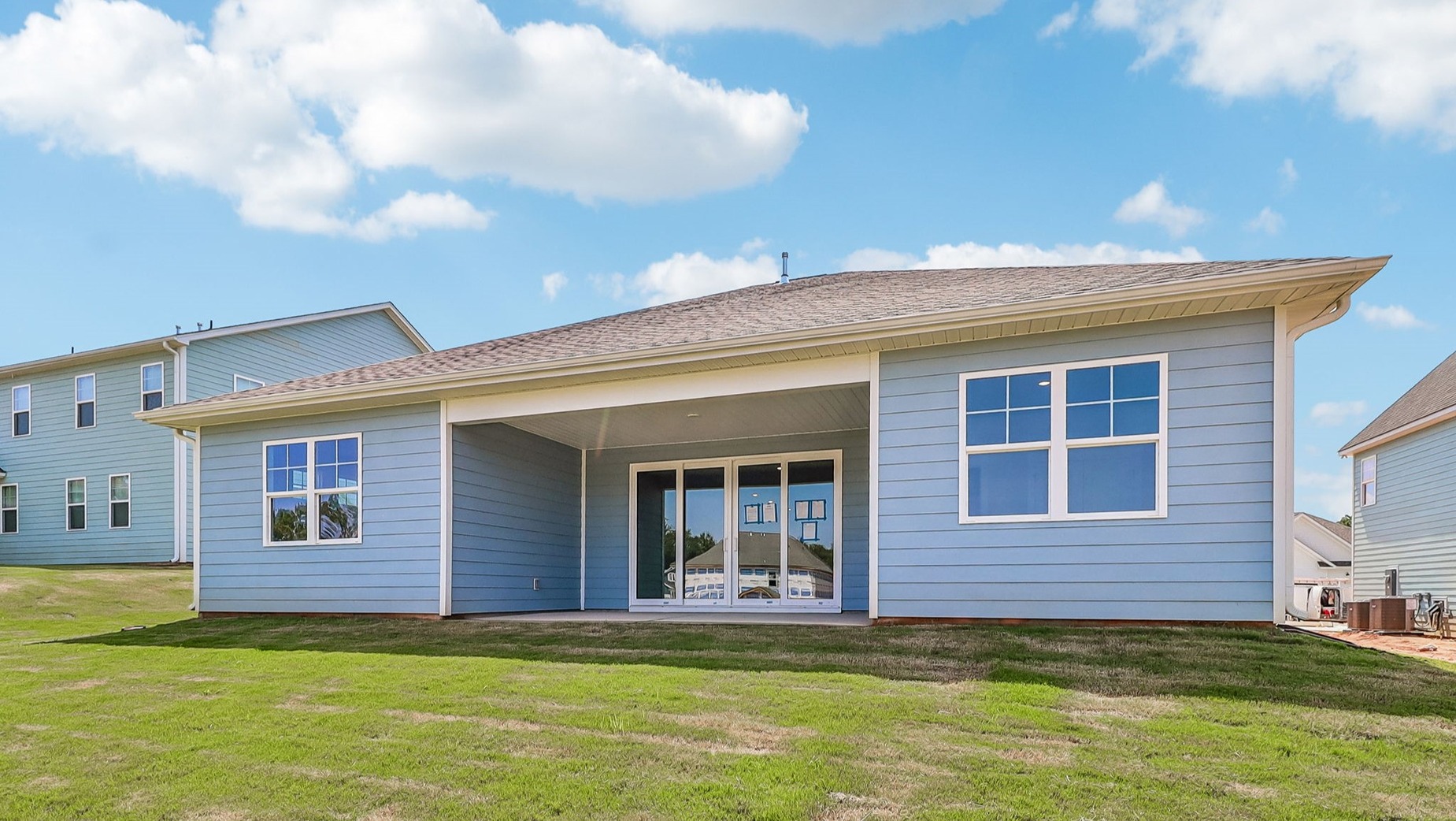 Back exterior of the home with blue Hardie Plank siding