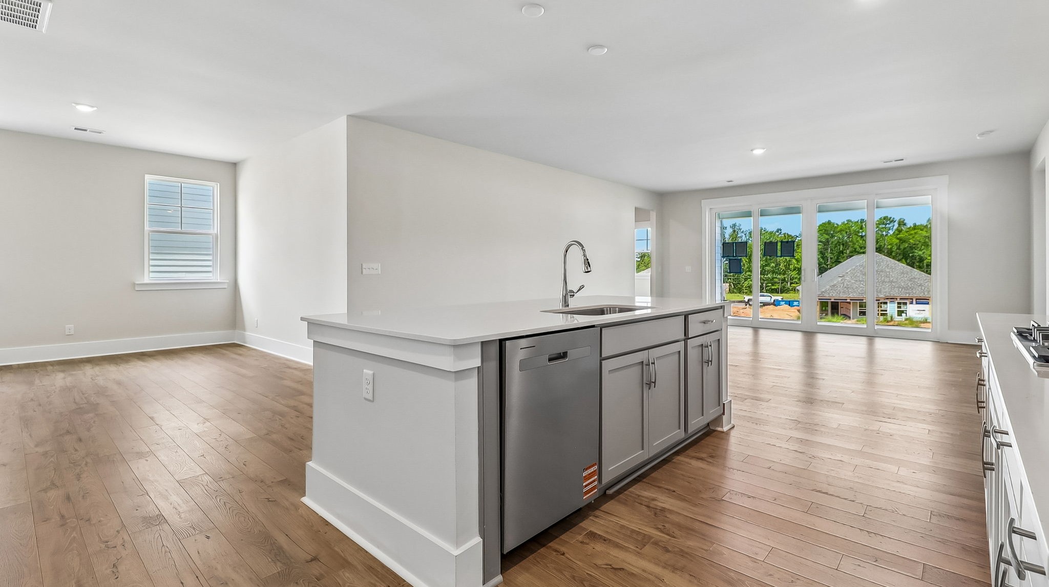 Floating kitchen island overlooks dining and living areas