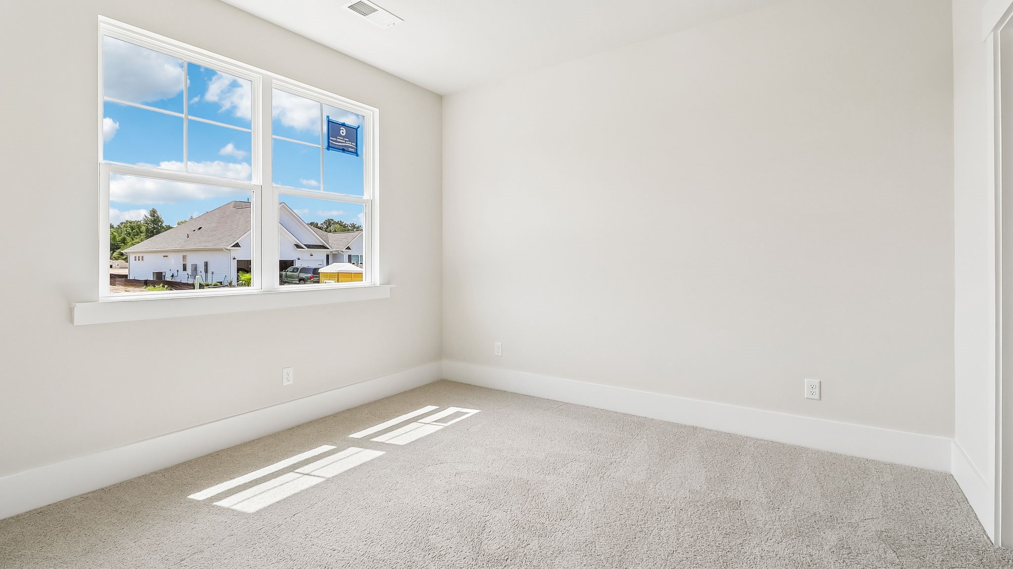 Front bedroom with large front-facing window for natural light
