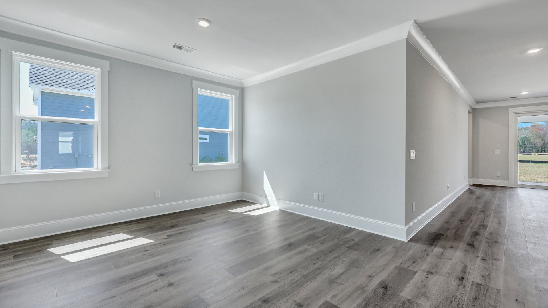 Dining area with 2 large windows and RevWood flooring