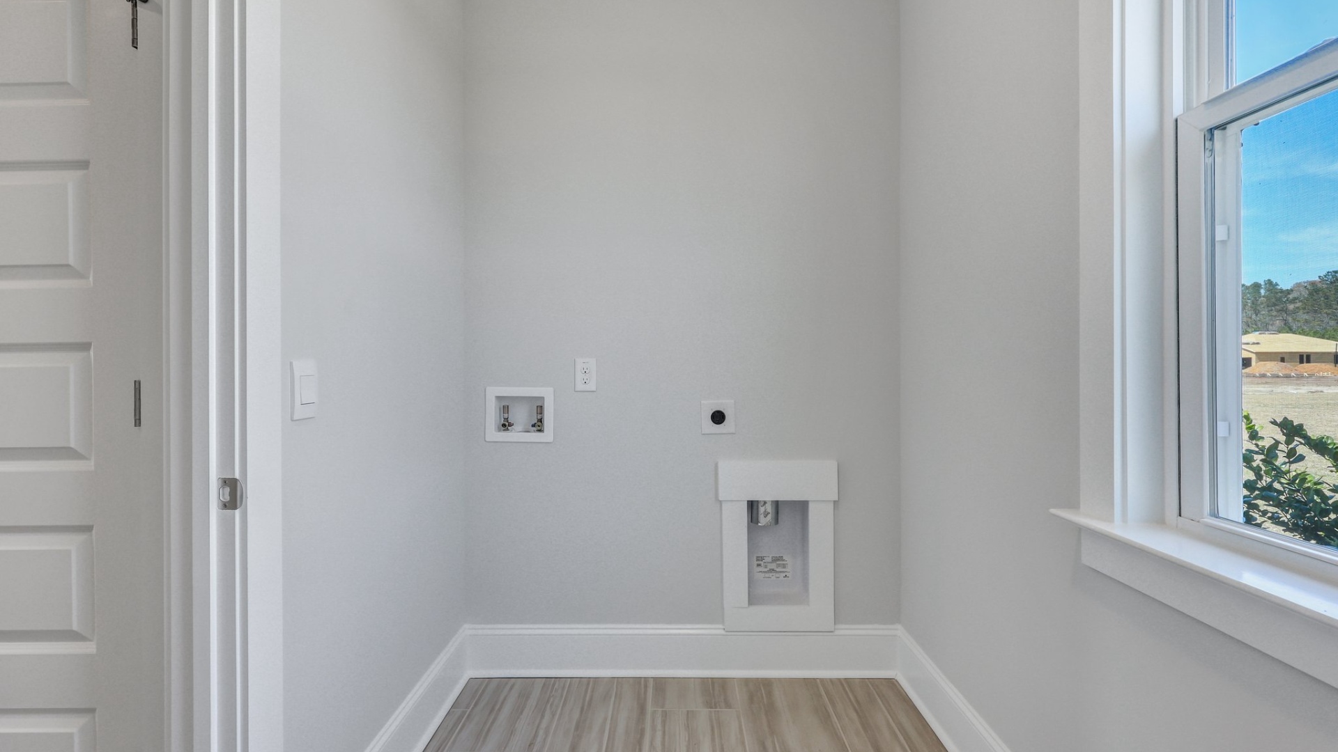 Laundry room off the kitchen space with natural light