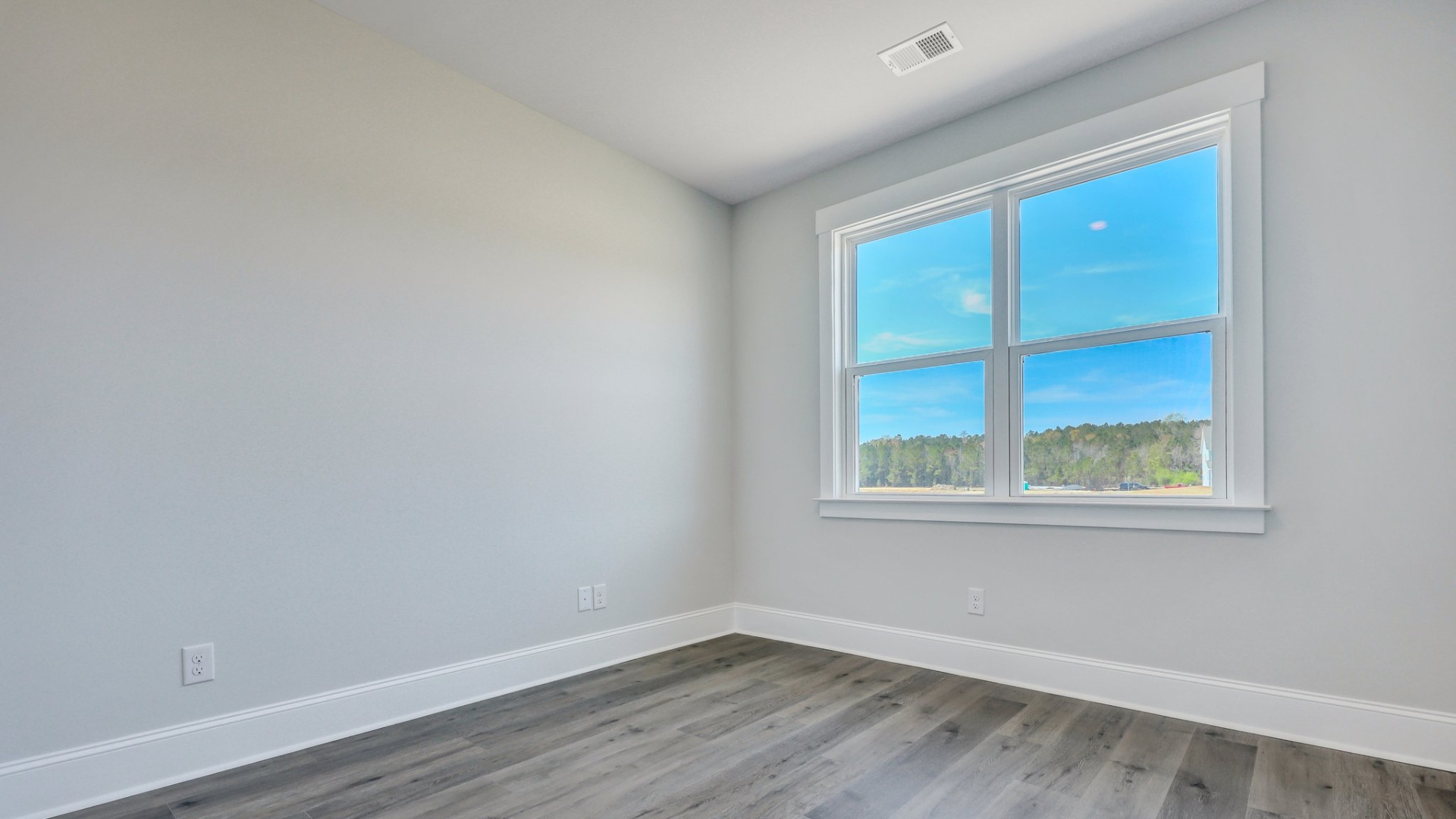 Bedroom 3 with a large window facing the backyard in Shell Pointe