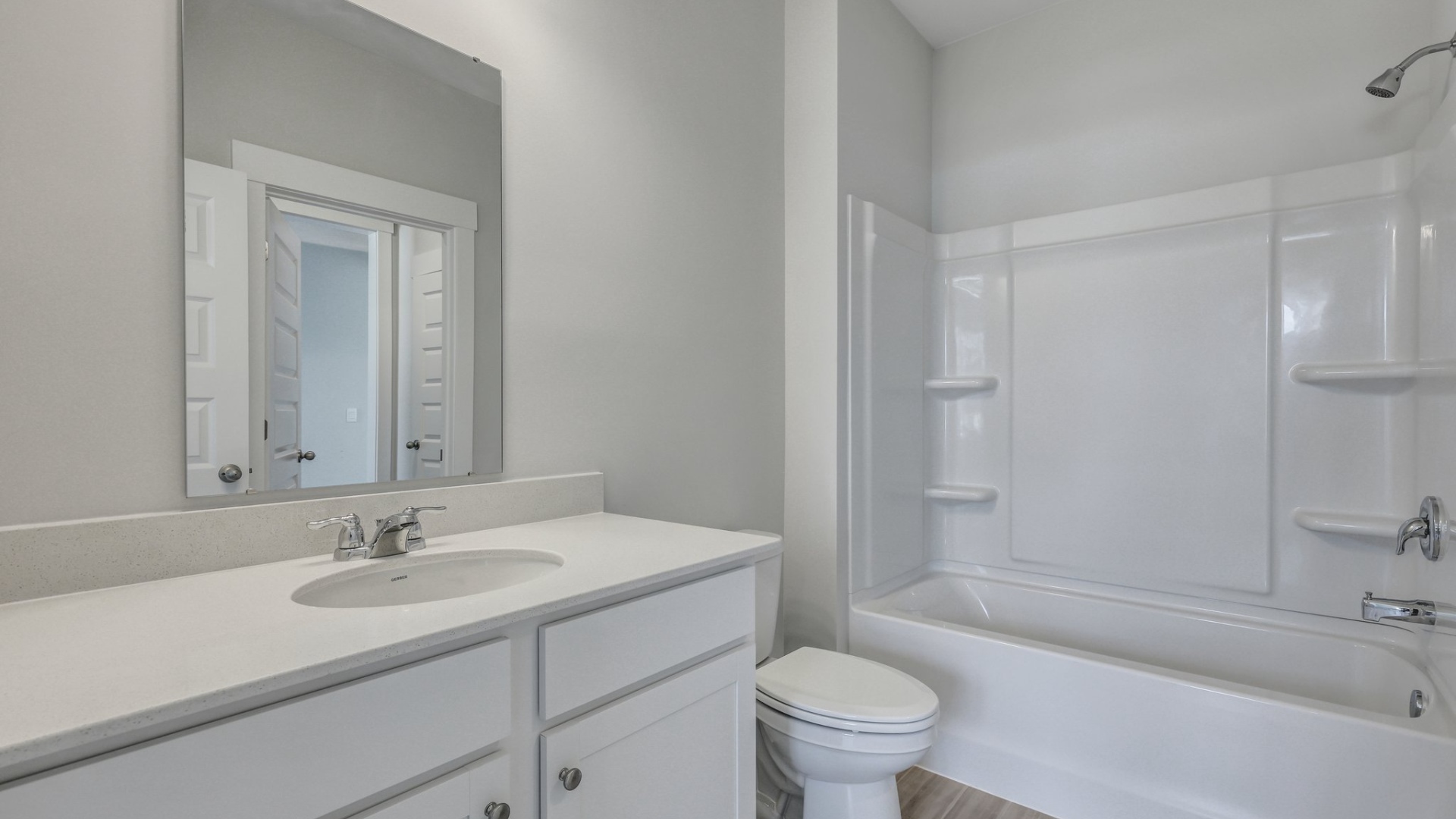 Bathroom 3 towards the front of the home with quartz countertops on the single-sink vanity