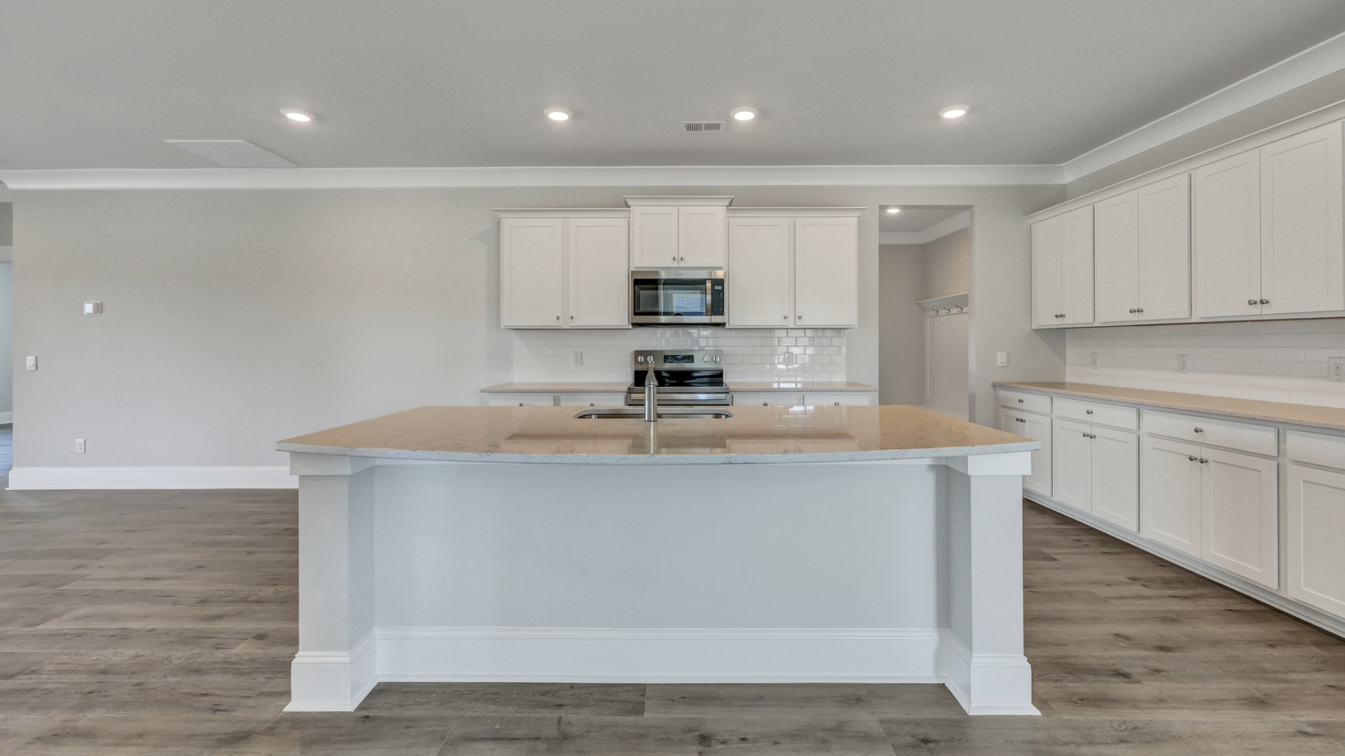 Trivecta floorplan kitchen with a floating island and white cabinets
