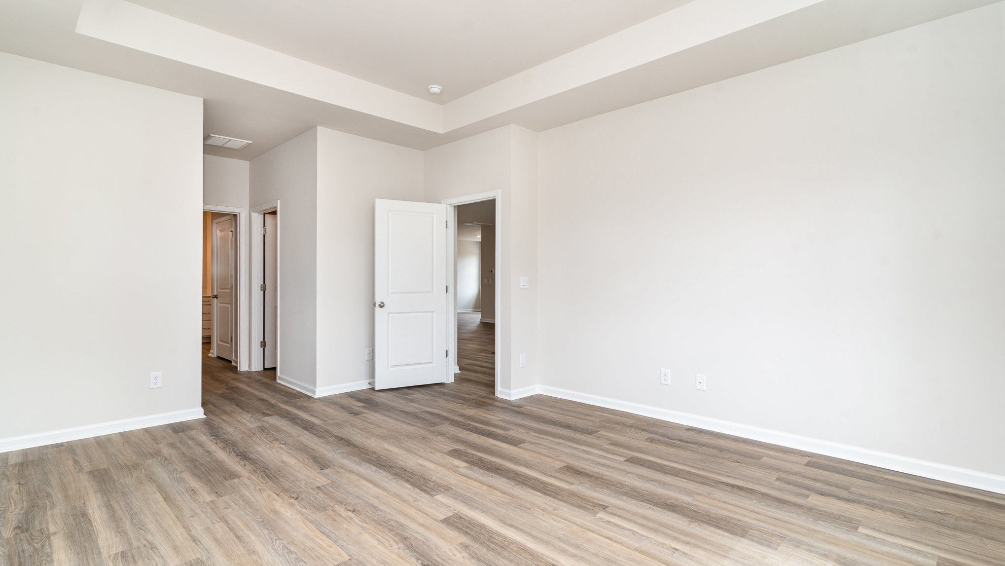 Primary bedroom with Revwood flooring
