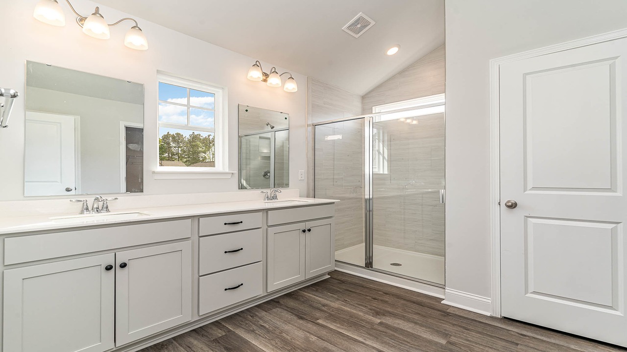 En-suite primary bathroom with standup shower and double vanity