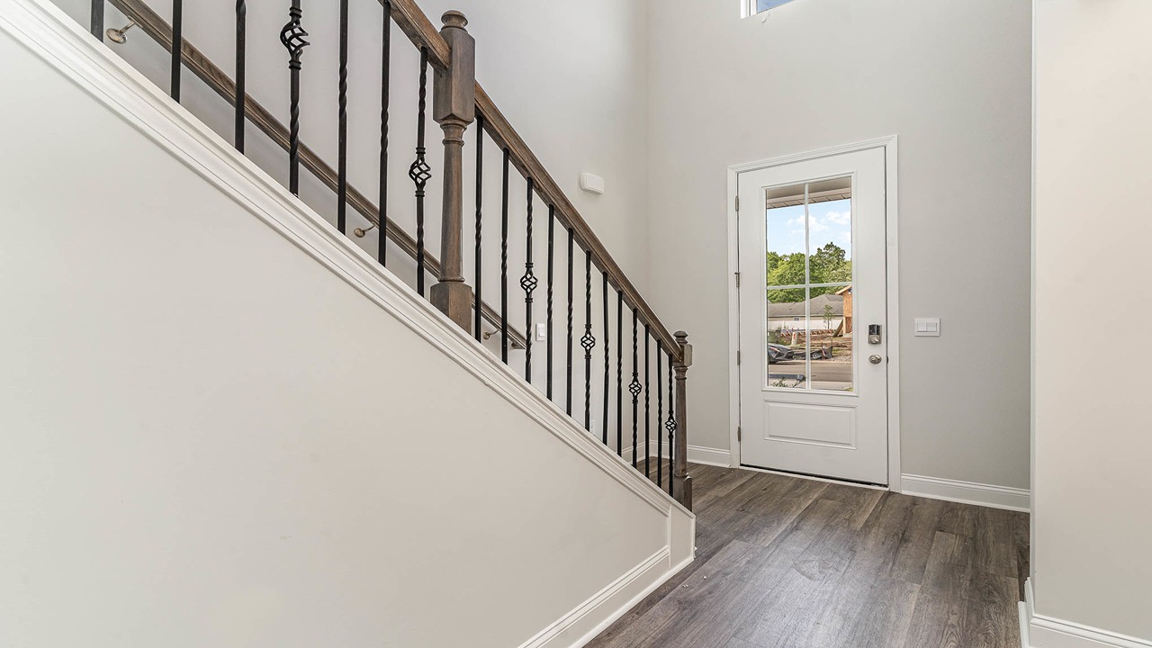 Front entrance with high ceilings and stairway to upstairs