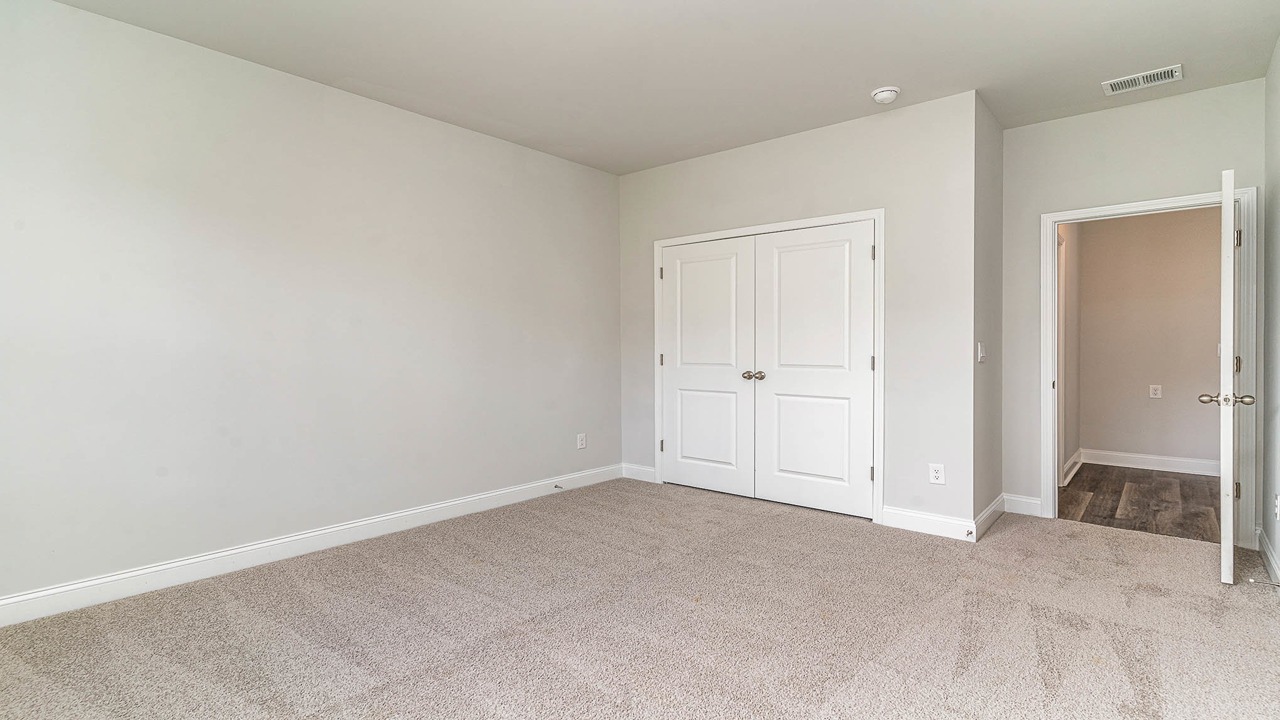 French closet doors in bedroom 2 of the Forrester floorplan in Shell Pointe