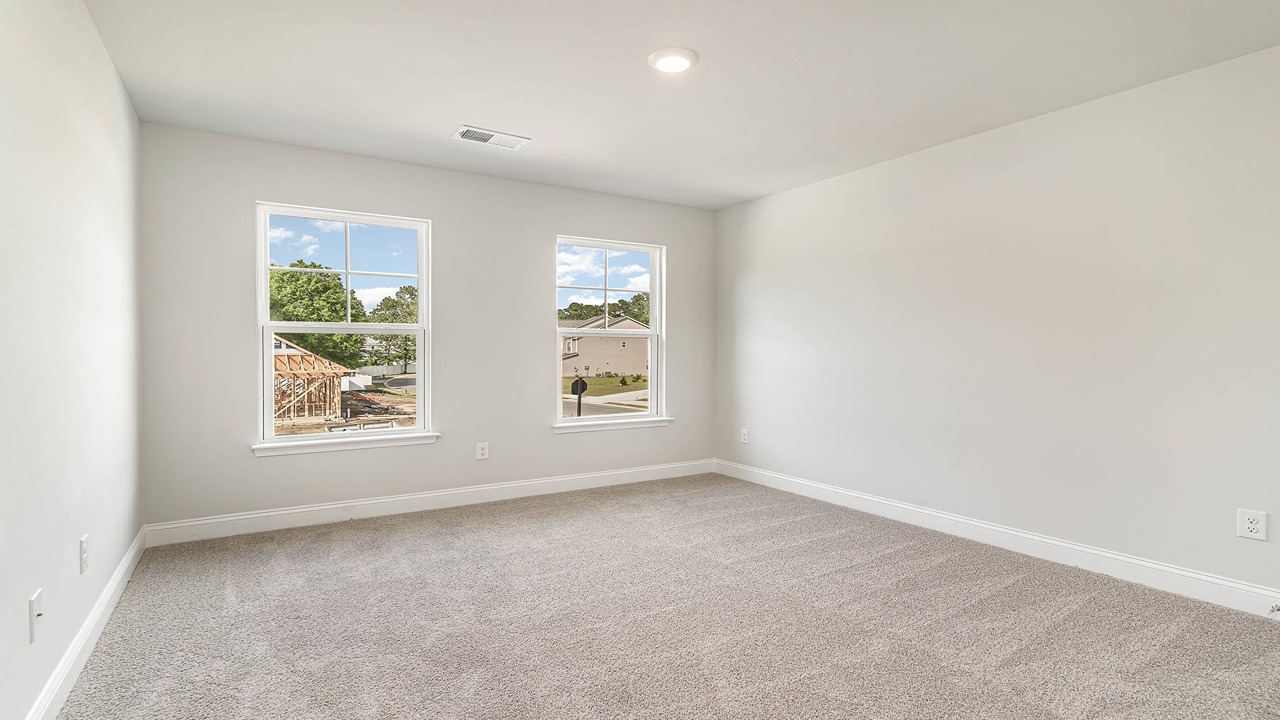 Bedroom 2 with windows for light and carpet floors