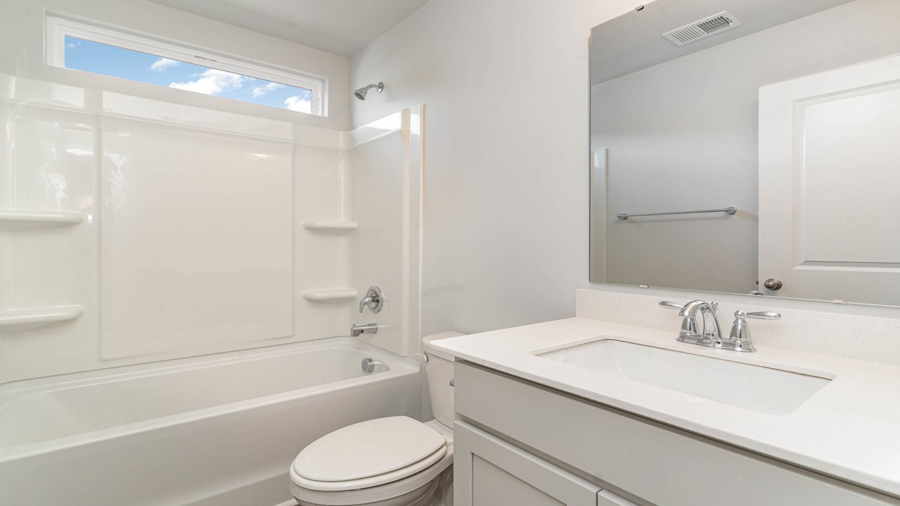 Bathroom 3 with a shower tub combo and white quartz countertops