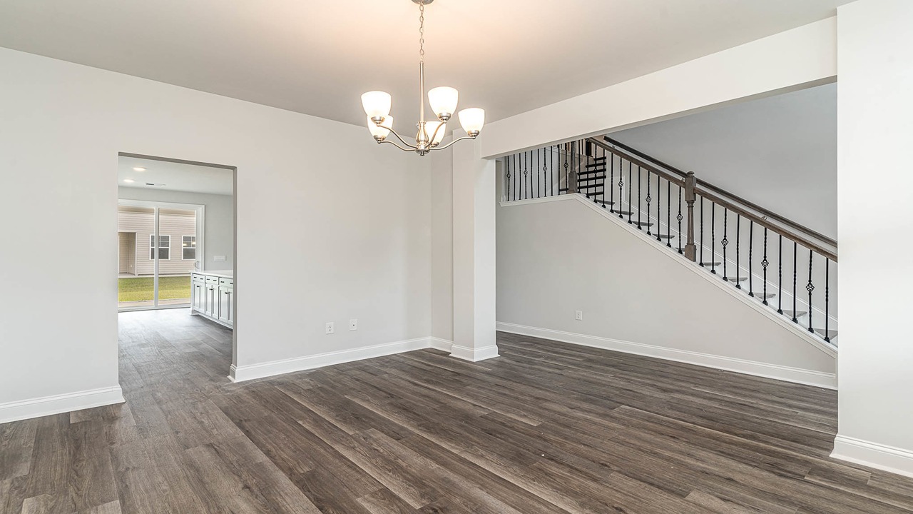 Dining area with RevWood flooring and access to both the kitchen and foyer