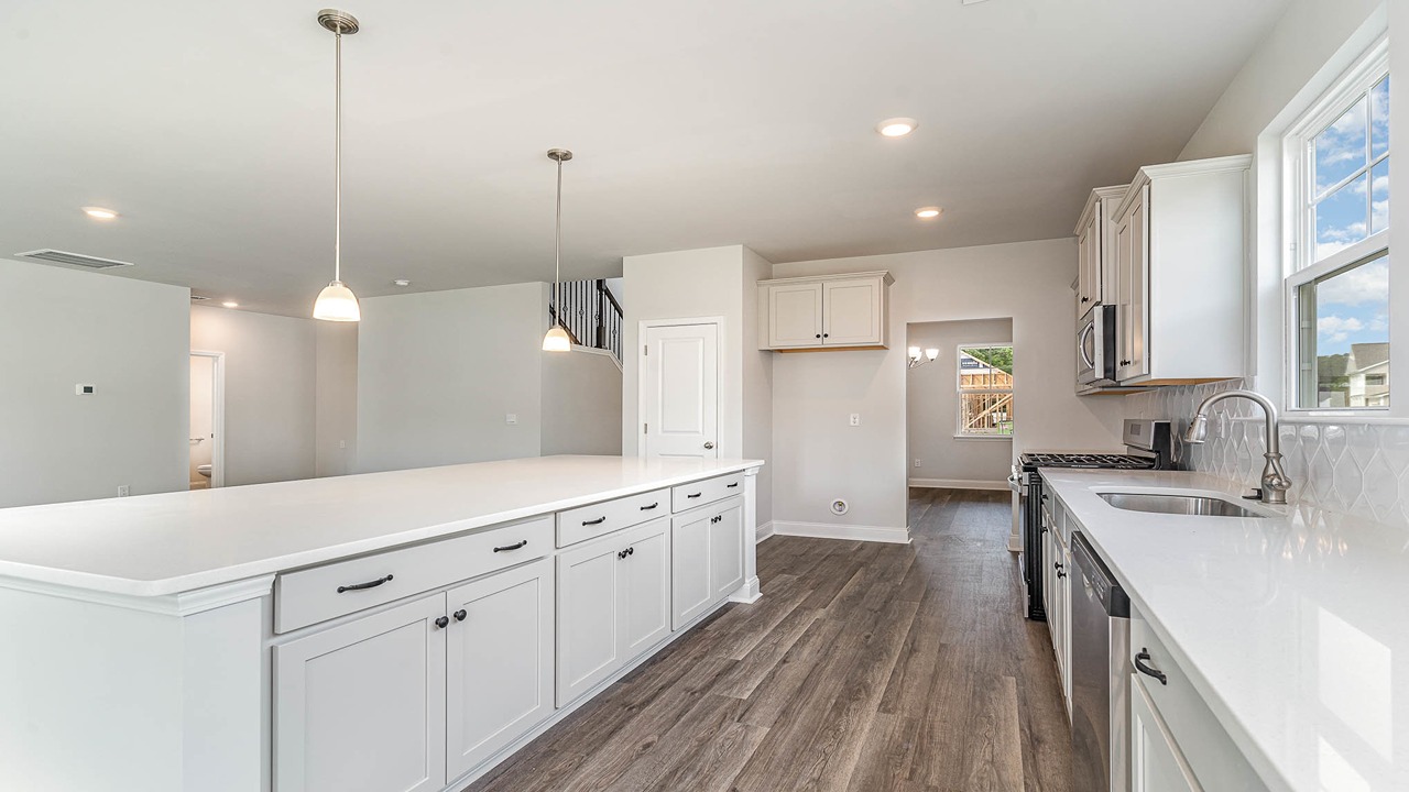White cabinets and white quartz countertops in the kitchen of home for sale at 325 Still Shores Drive