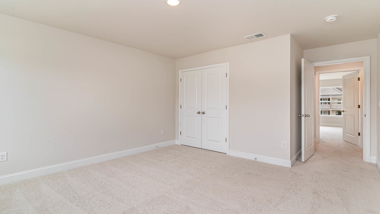 Upstairs bedrooms with carpet flooring.
