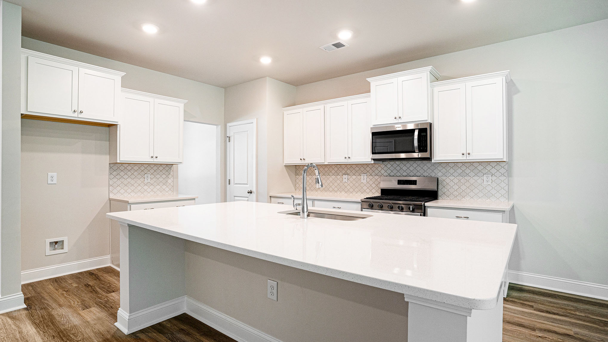 Sleek, white quartz countertops in kitchen