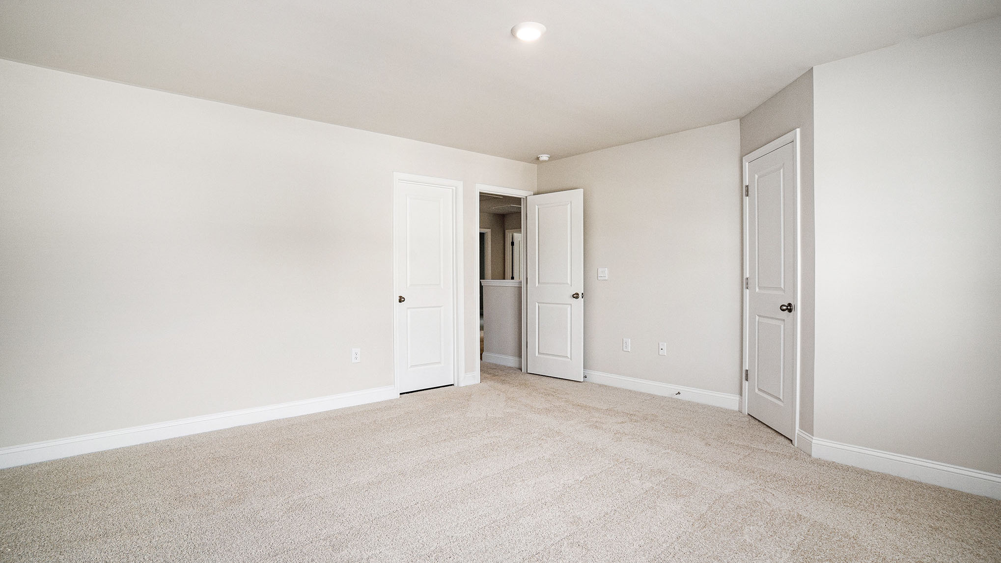 Spacious bedroom 2 upstairs with neutral-painted walls