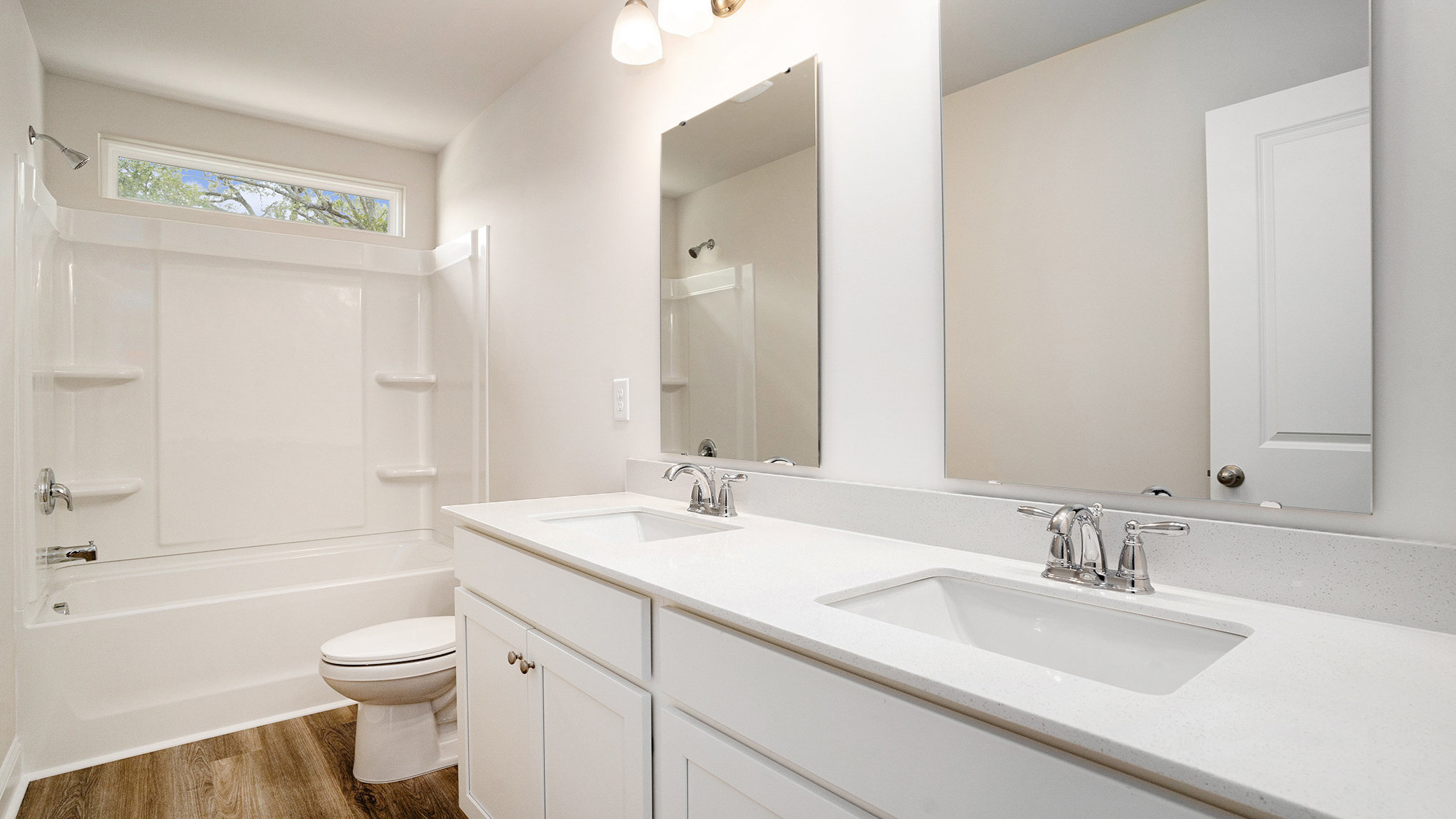 Bathroom 3 upstairs with double vanity and white cabinetry