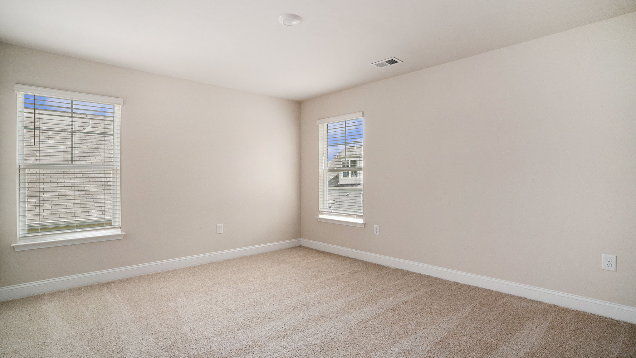 Bedroom 3 with windows and carpet flooring