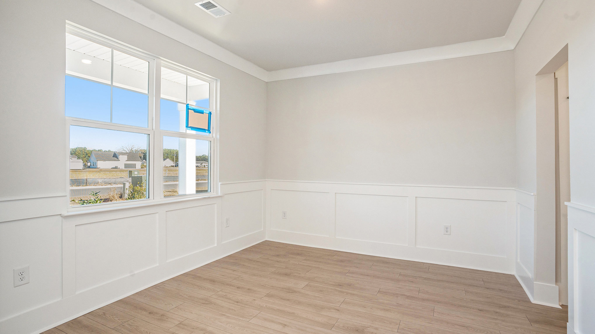 Dining area with Revwood flooring and a window