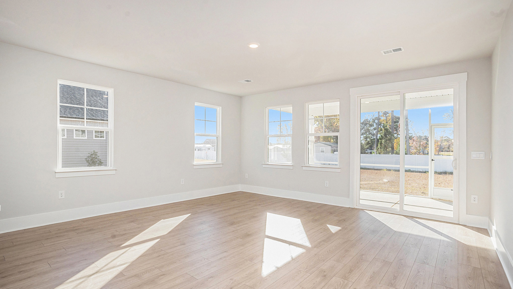 Living area with lots of natural light and access to back covered patio